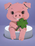 Pink wooden piglet shelf sitter holding a green four-leaf clover